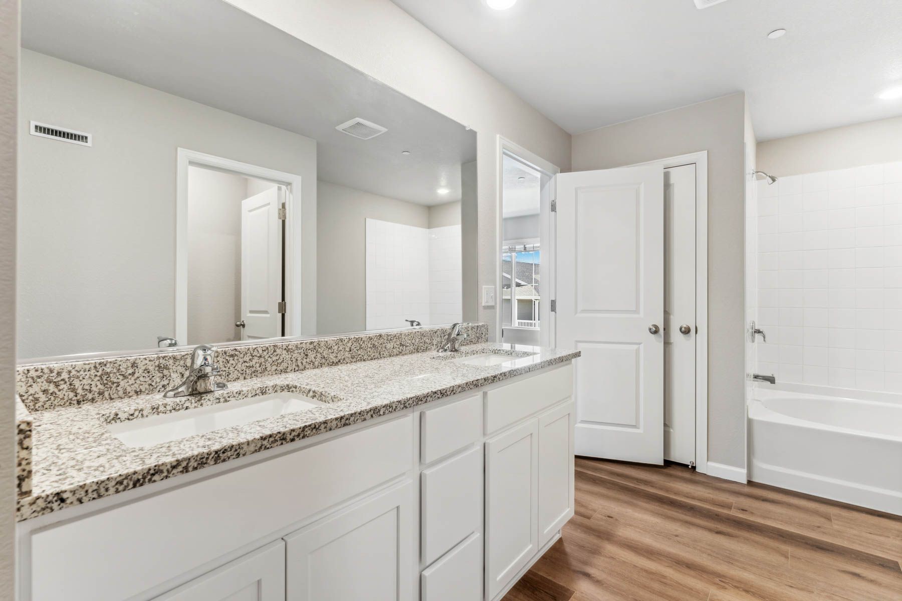 The master bathroom has a dual sink vanity.