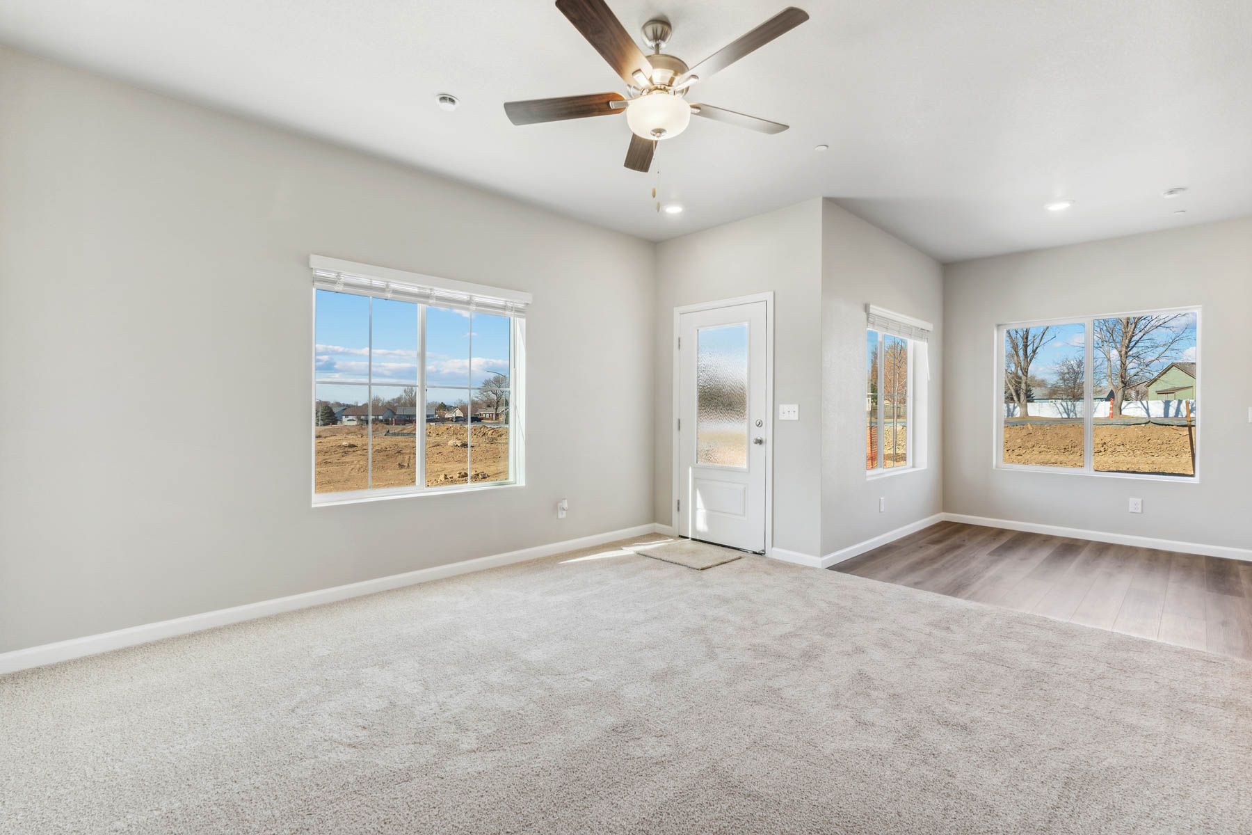 The spacious family room has a ceiling fan and is off of the dining room.