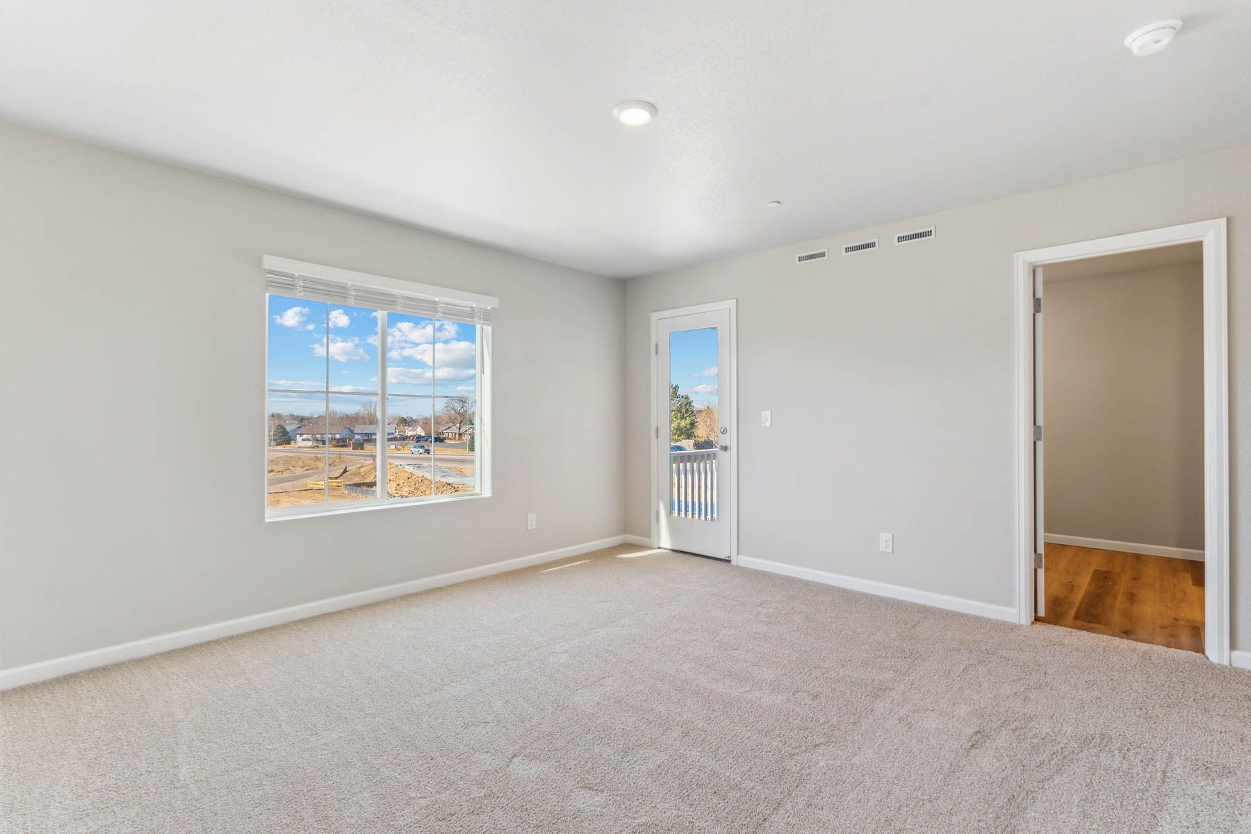 The master bedroom is spacious with a large window.