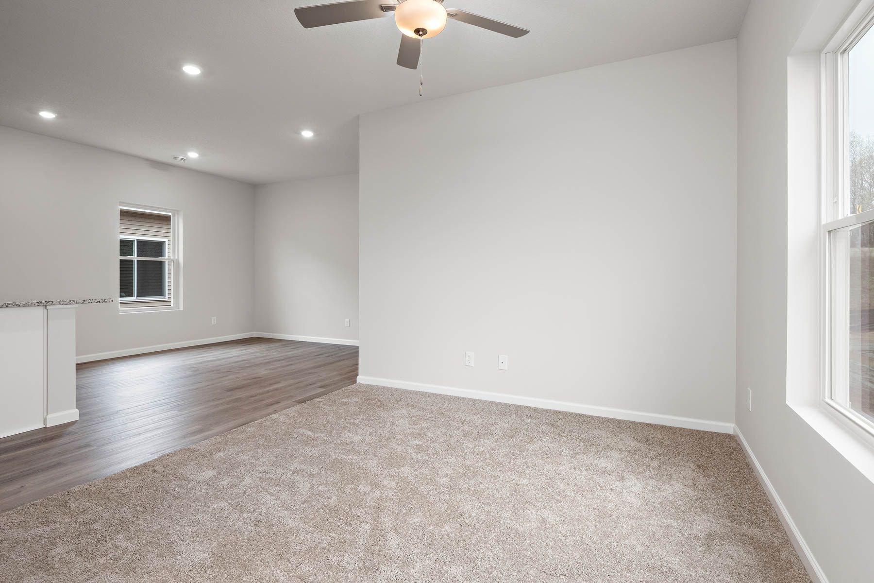 The family room is spacious with a ceiling fan.