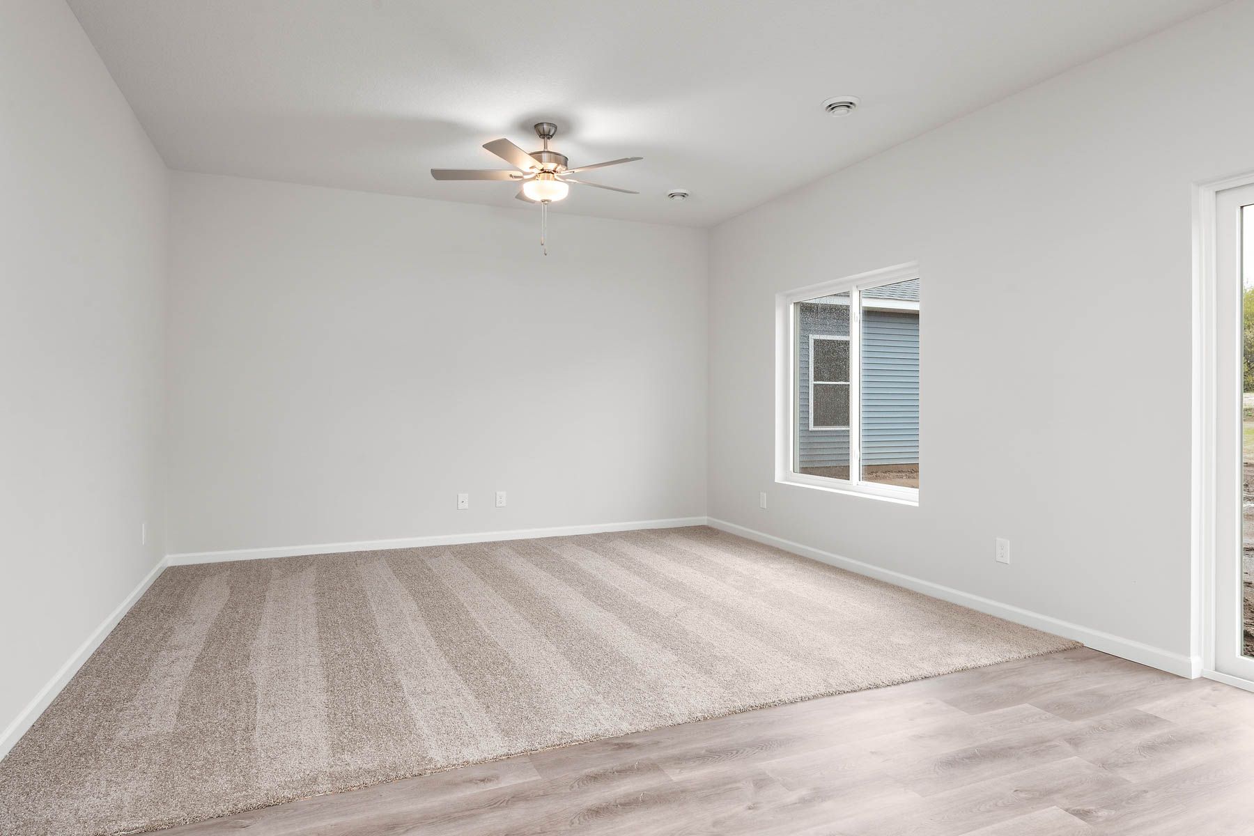 The family room is spacious with a ceiling fan.