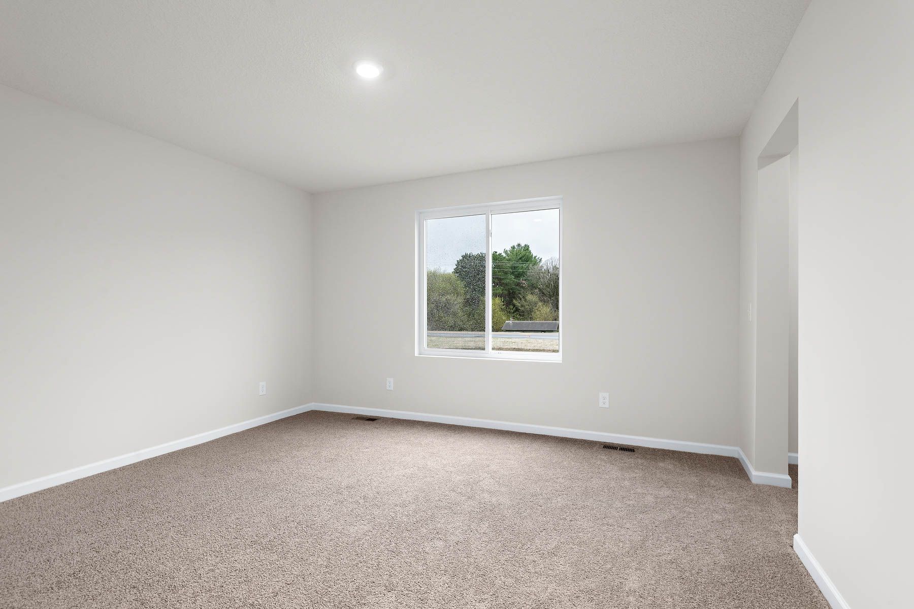 The master bedroom is spacious with a large window.
