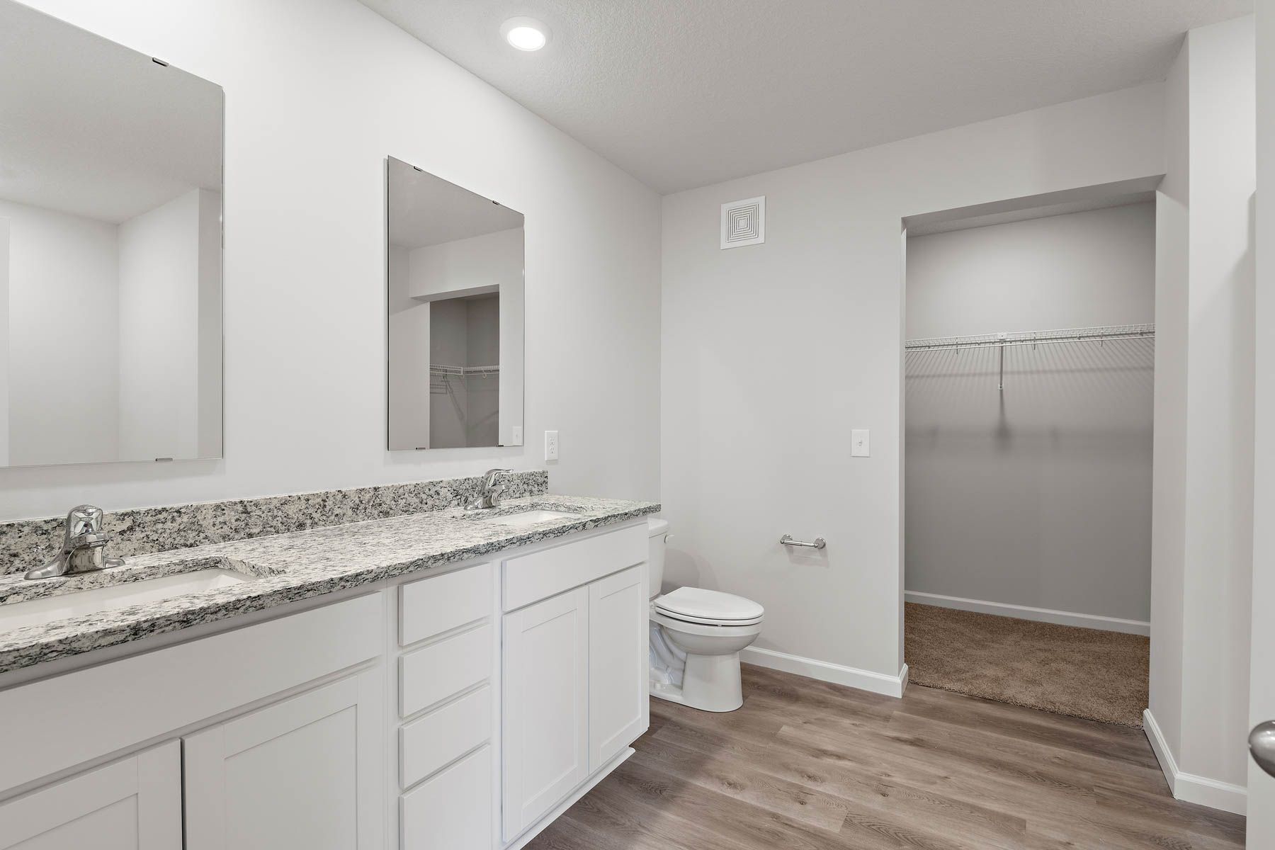 The master bathroom has a dual sink vanity.