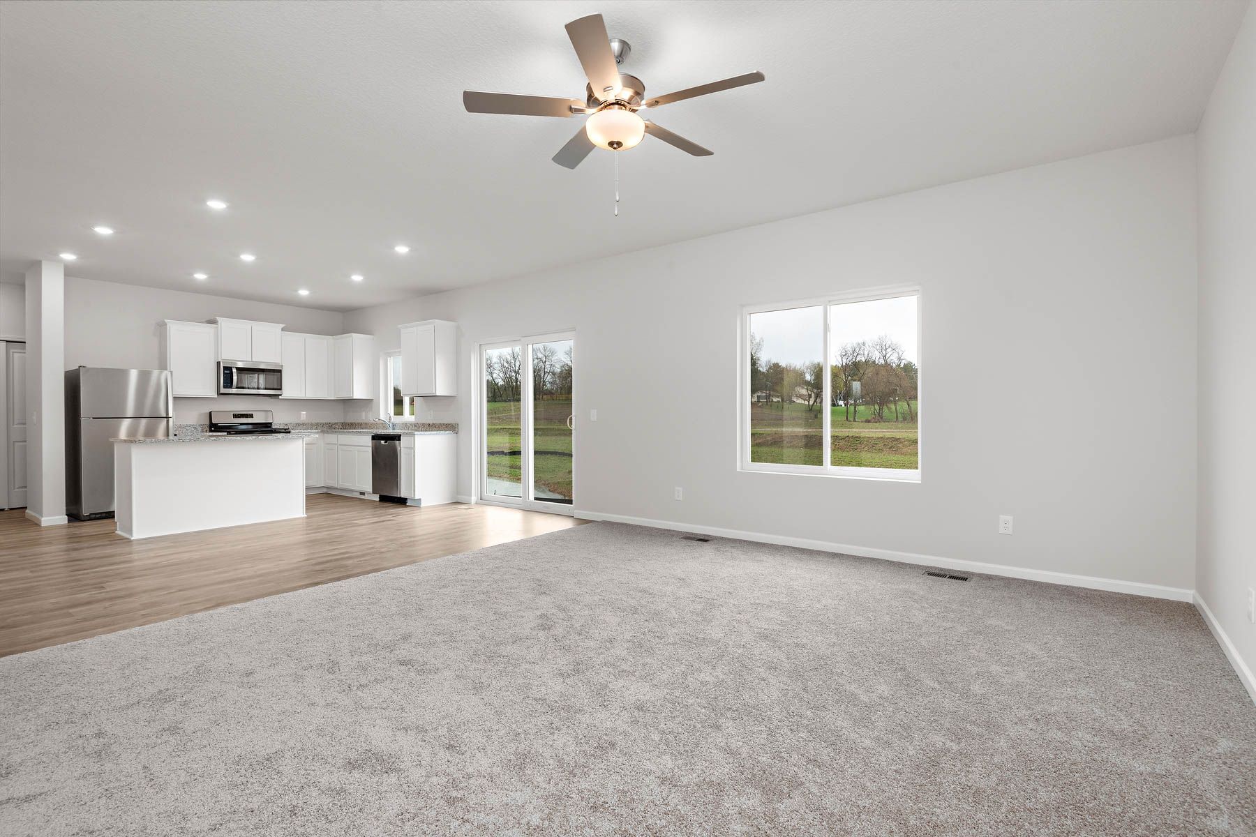 The family room is spacious with a ceiling fan.