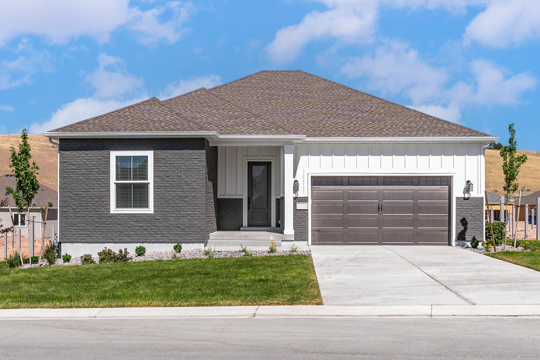 The Crawford is a beautiful single-story home with siding and brick.