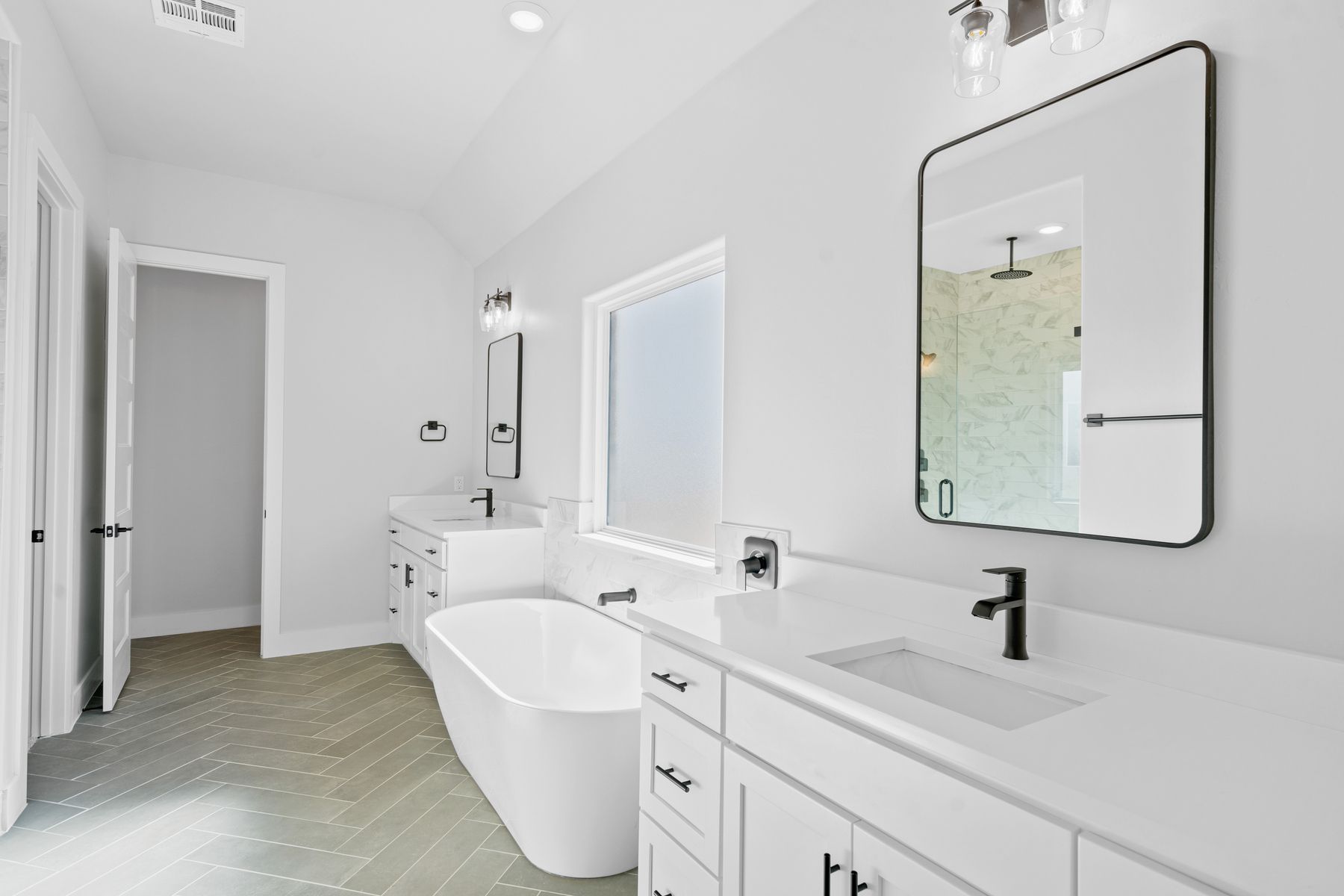  The master bathroom has two large vanities with a stunning stand-alone soaker tub.