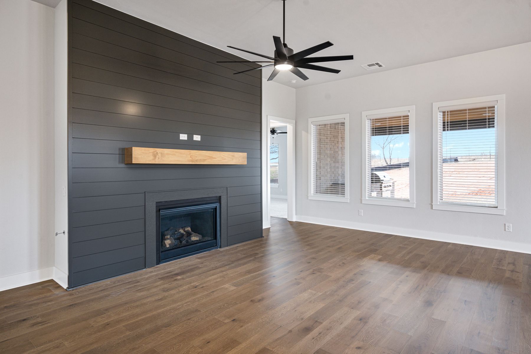 The family room is large and has lots of windows and a gas fireplace.