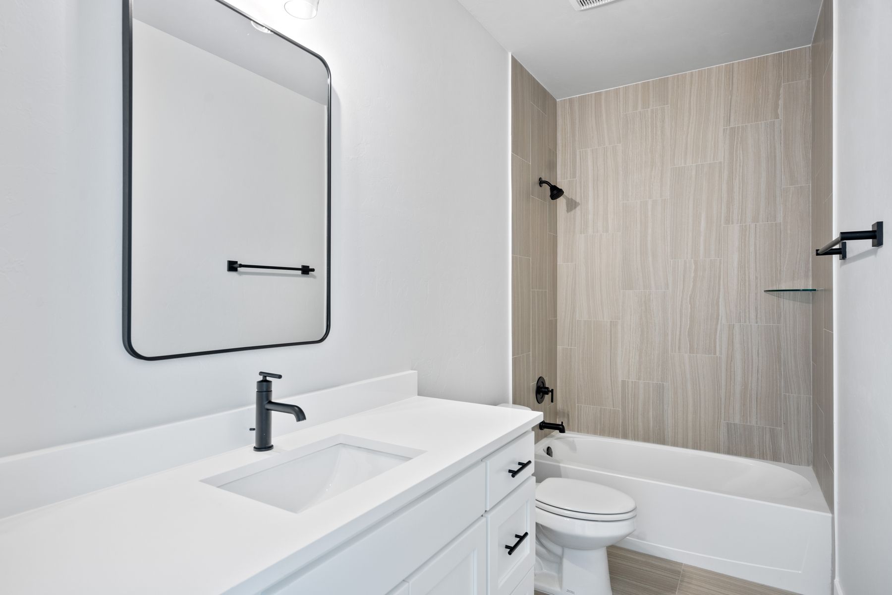 The secondary bathroom has a large vanity space.