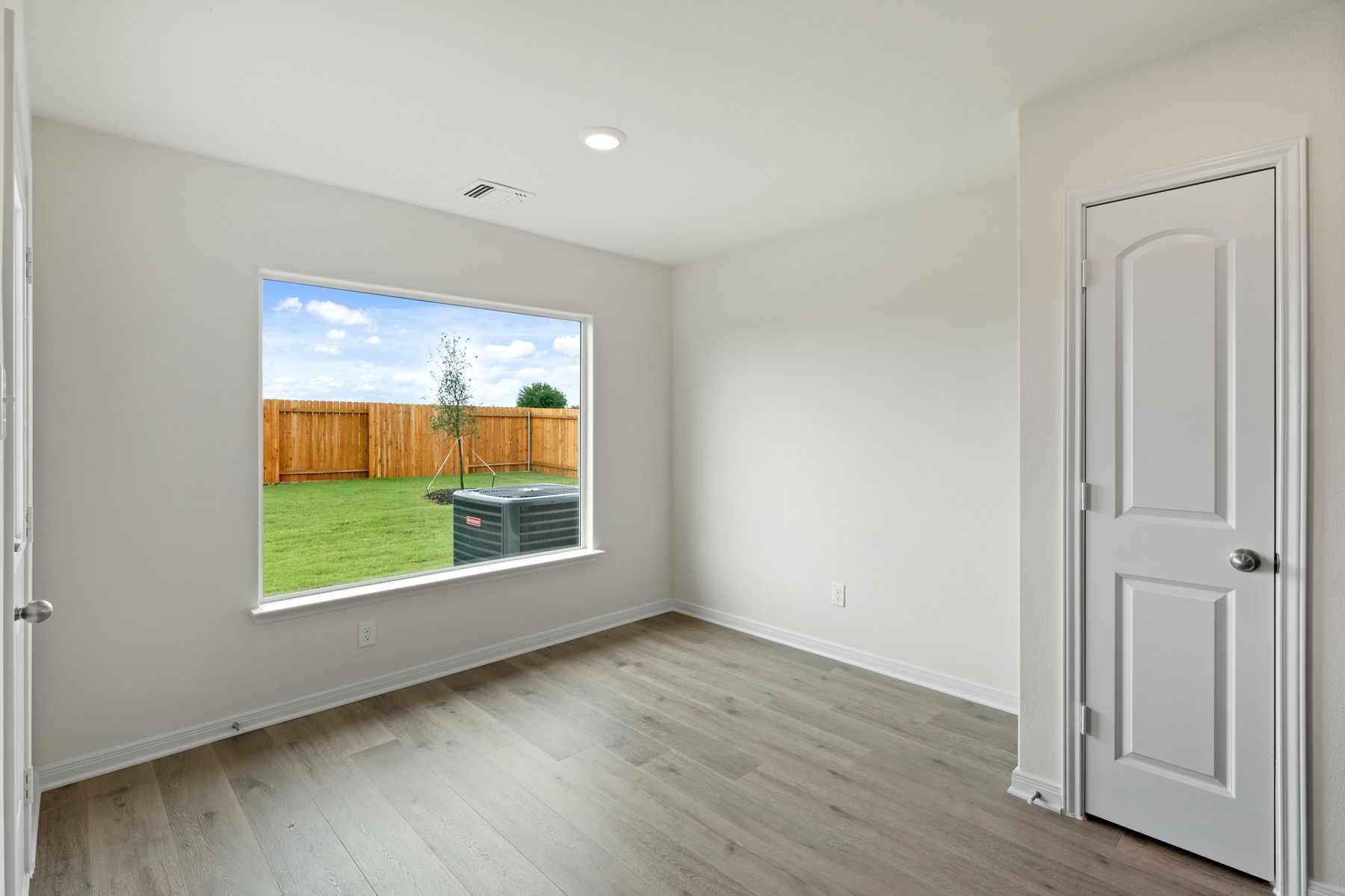 The dining room of sits right off of the kitchen and has a large window.