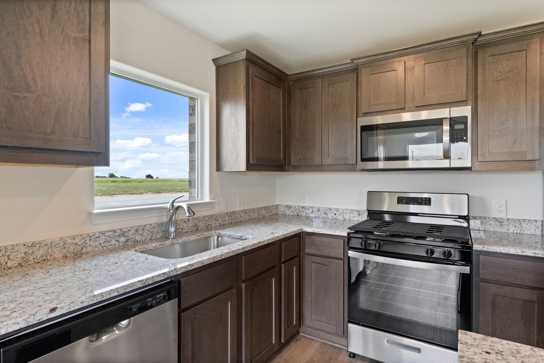 The kitchen has sprawling granite countertops.