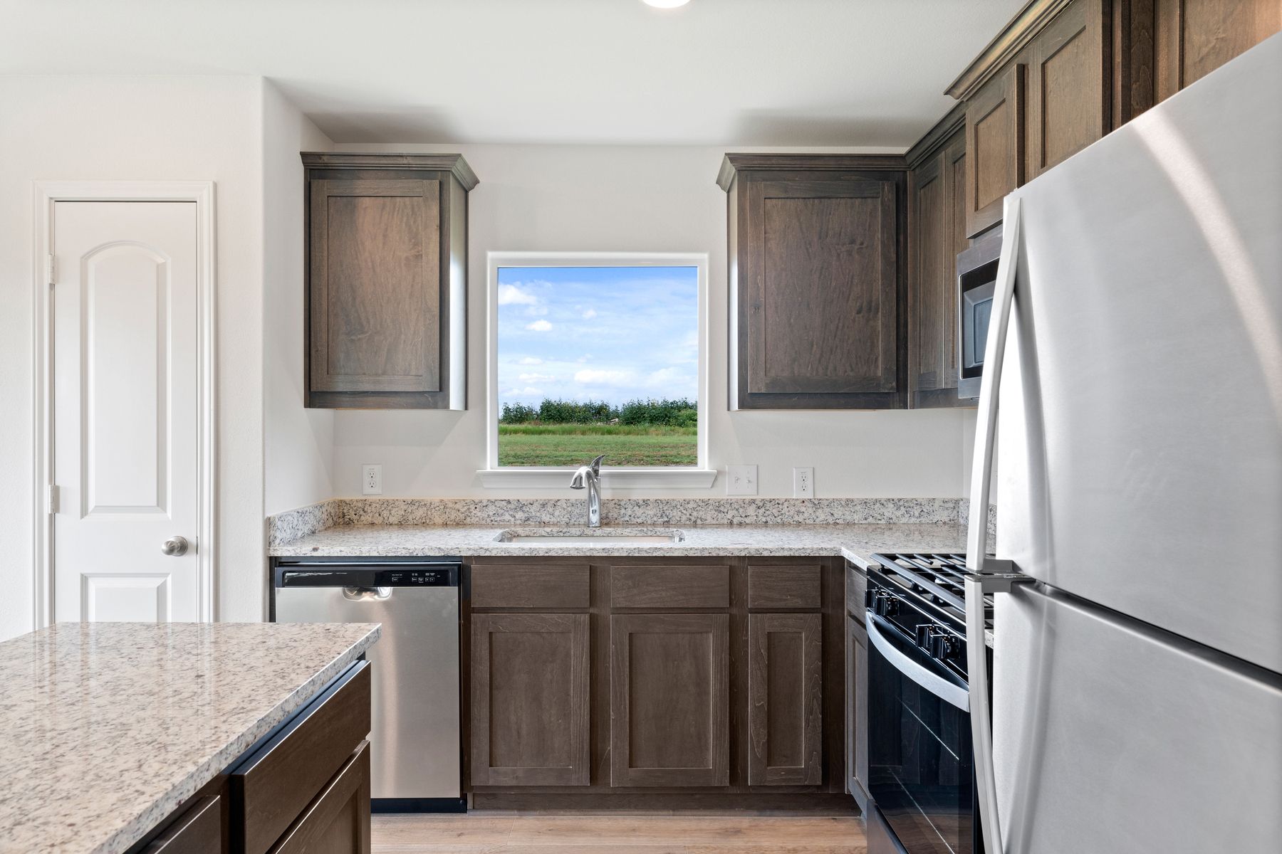 The kitchen has gorgeous wood cabinetry.