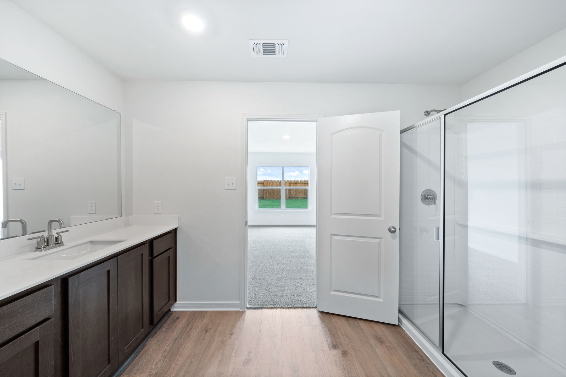 The master bathroom has a large glass, walk-in shower.