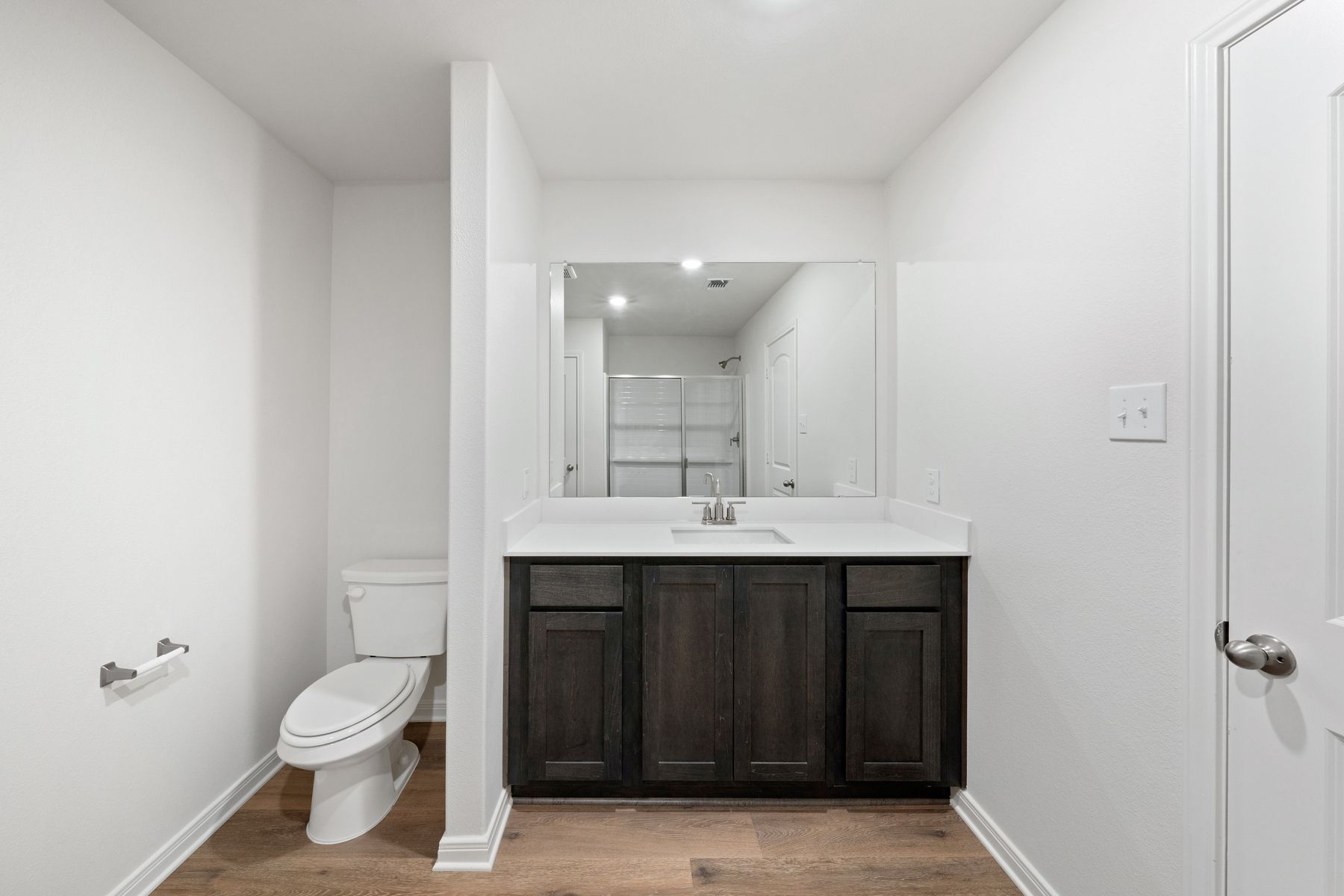 The master bathroom has a spacious vanity space.