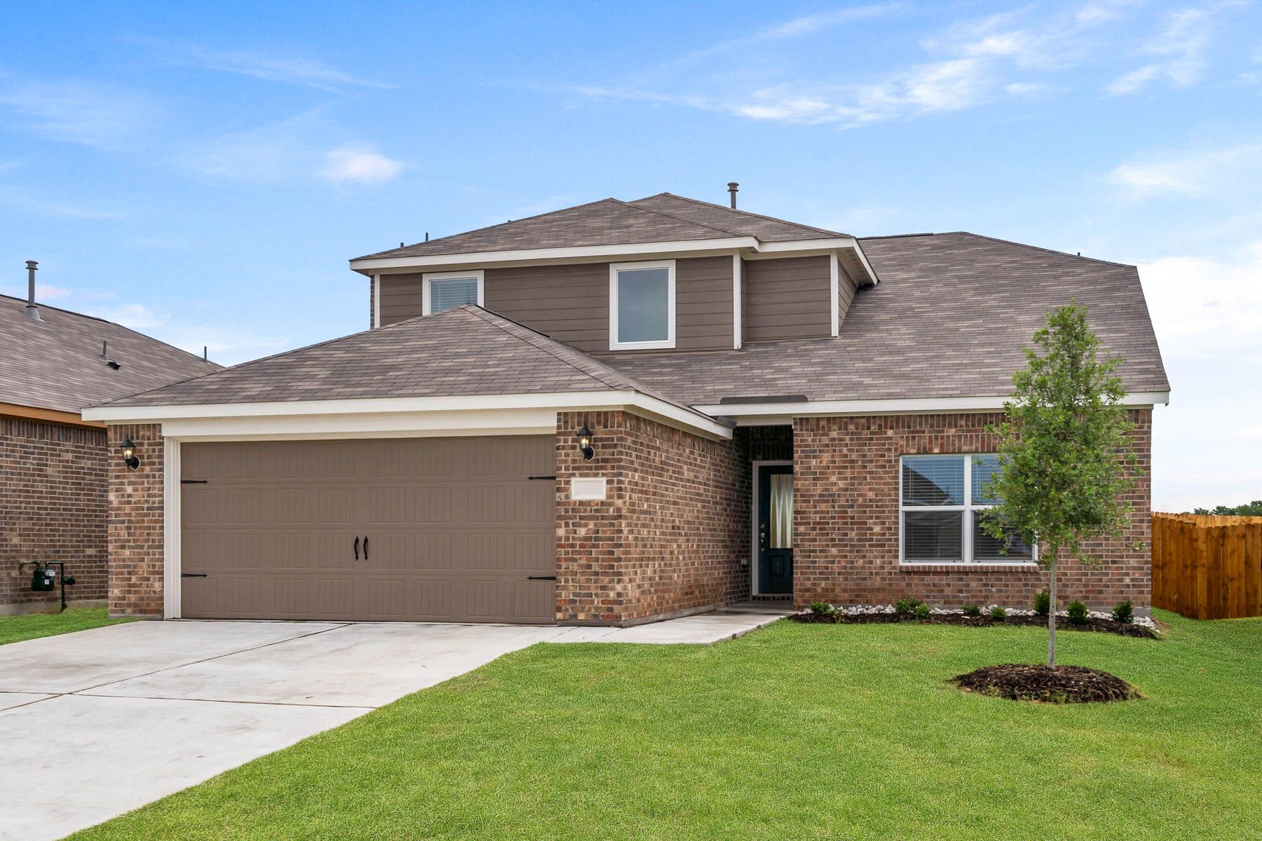 The Cypress is a beautiful two-story, brick home with siding details.