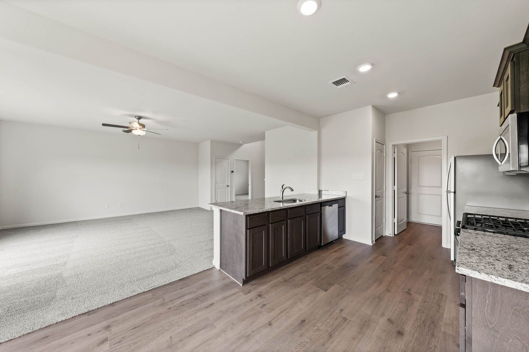 The open layout connects the kitchen with the dining room and family room.