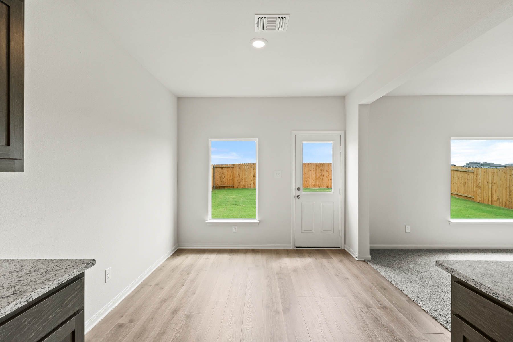 The dining room sits right off of the kitchen has a large window.