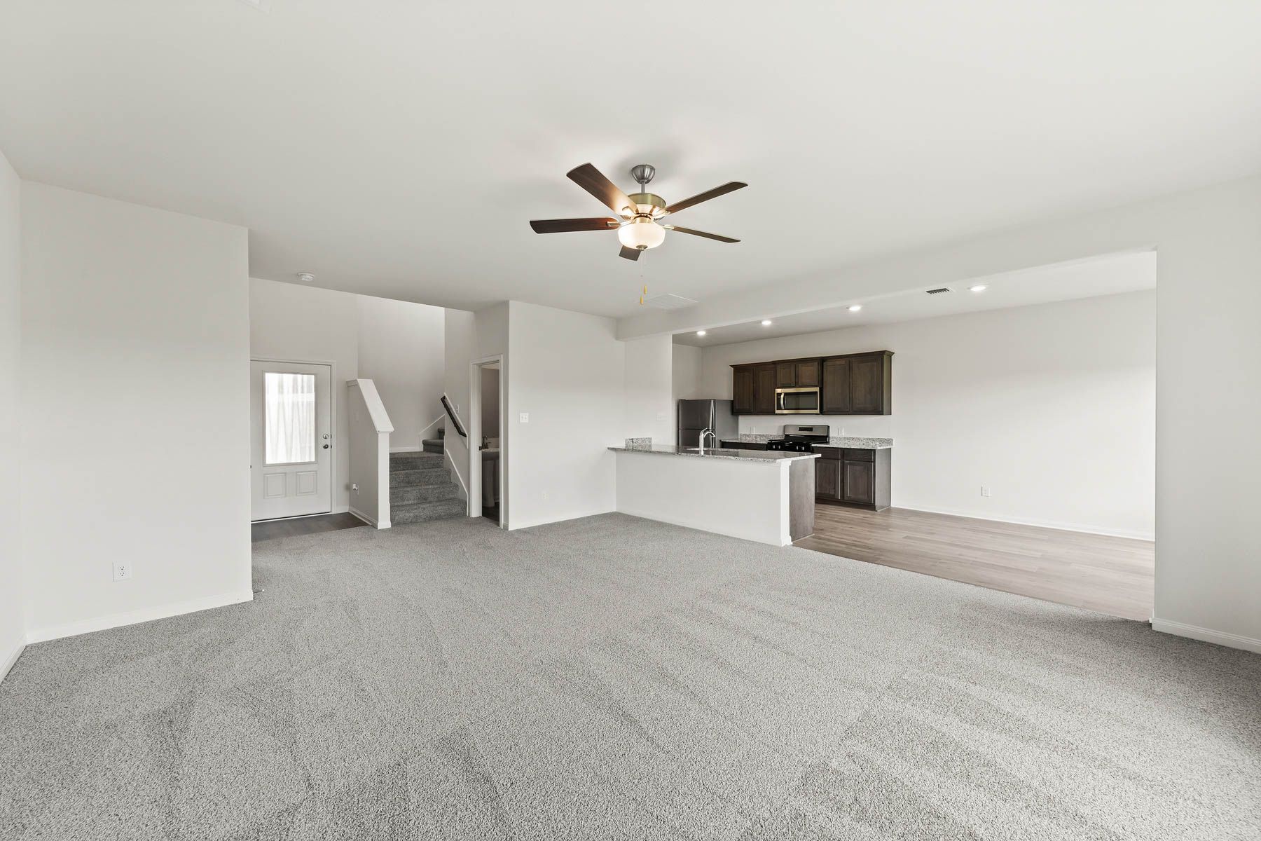 The open layout connects the kitchen with the dining room and family room.
