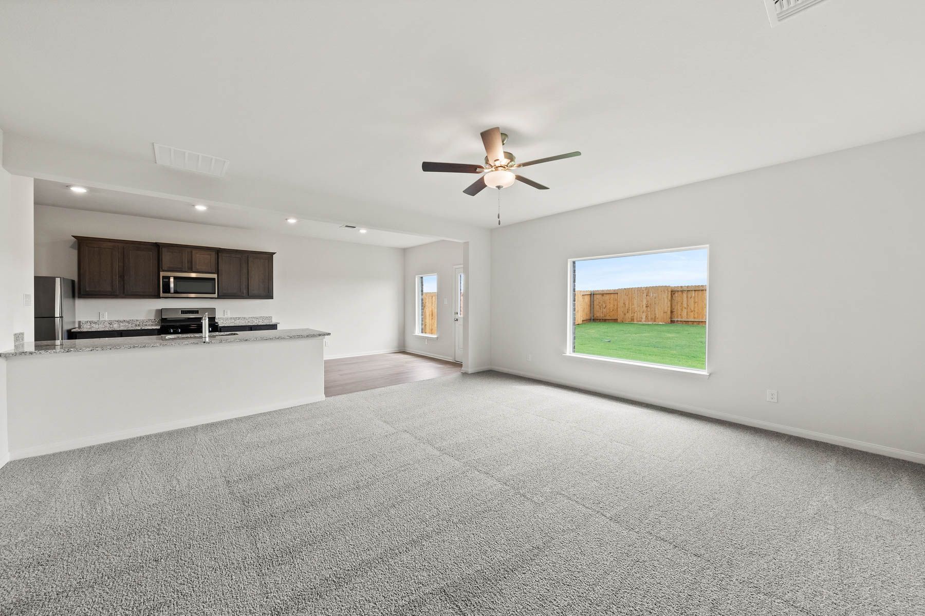 The open layout connects the kitchen with the dining room and family room.