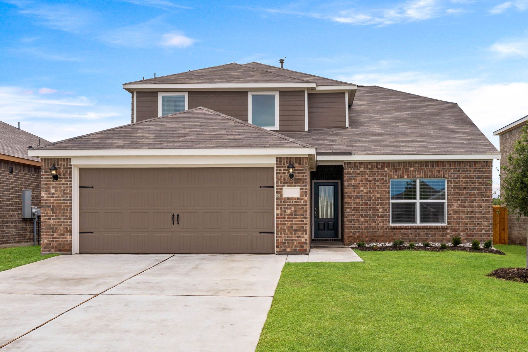 The Cypress is a beautiful two-story, brick home with siding details.