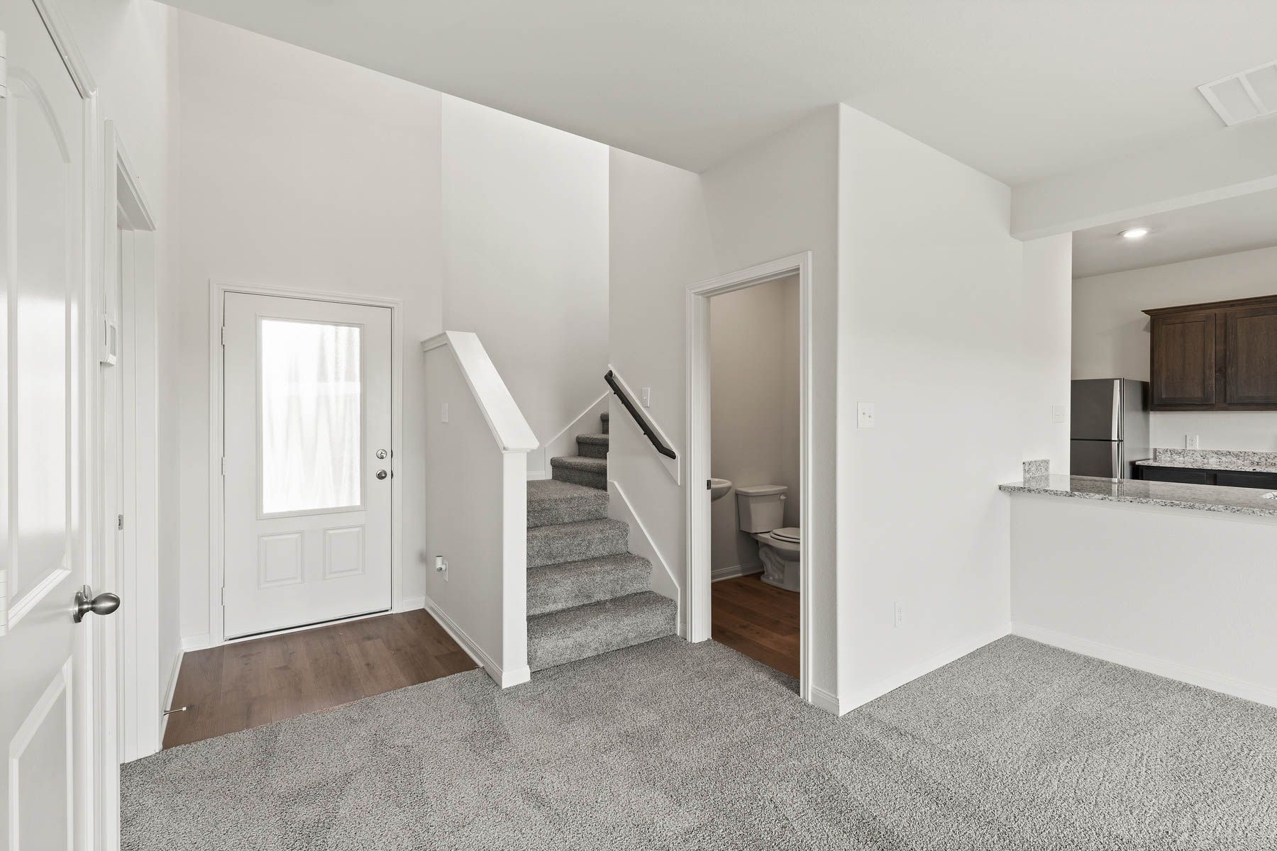 The downstairs powder room is located right off of the family room for convenient access.