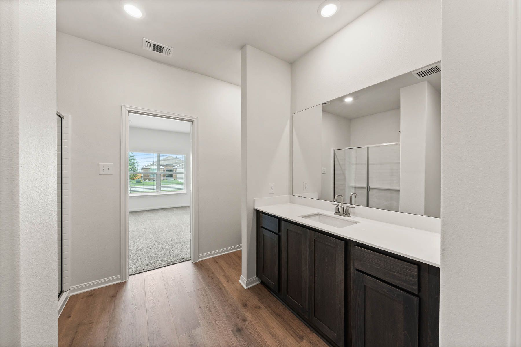 The master bathroom has a large vanity space.