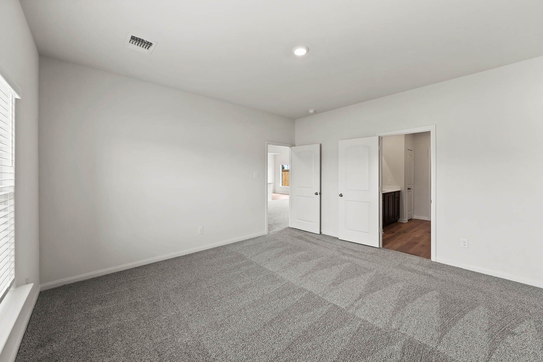 The master suite has a large bedroom, en-suite bathroom and walk-in closet.