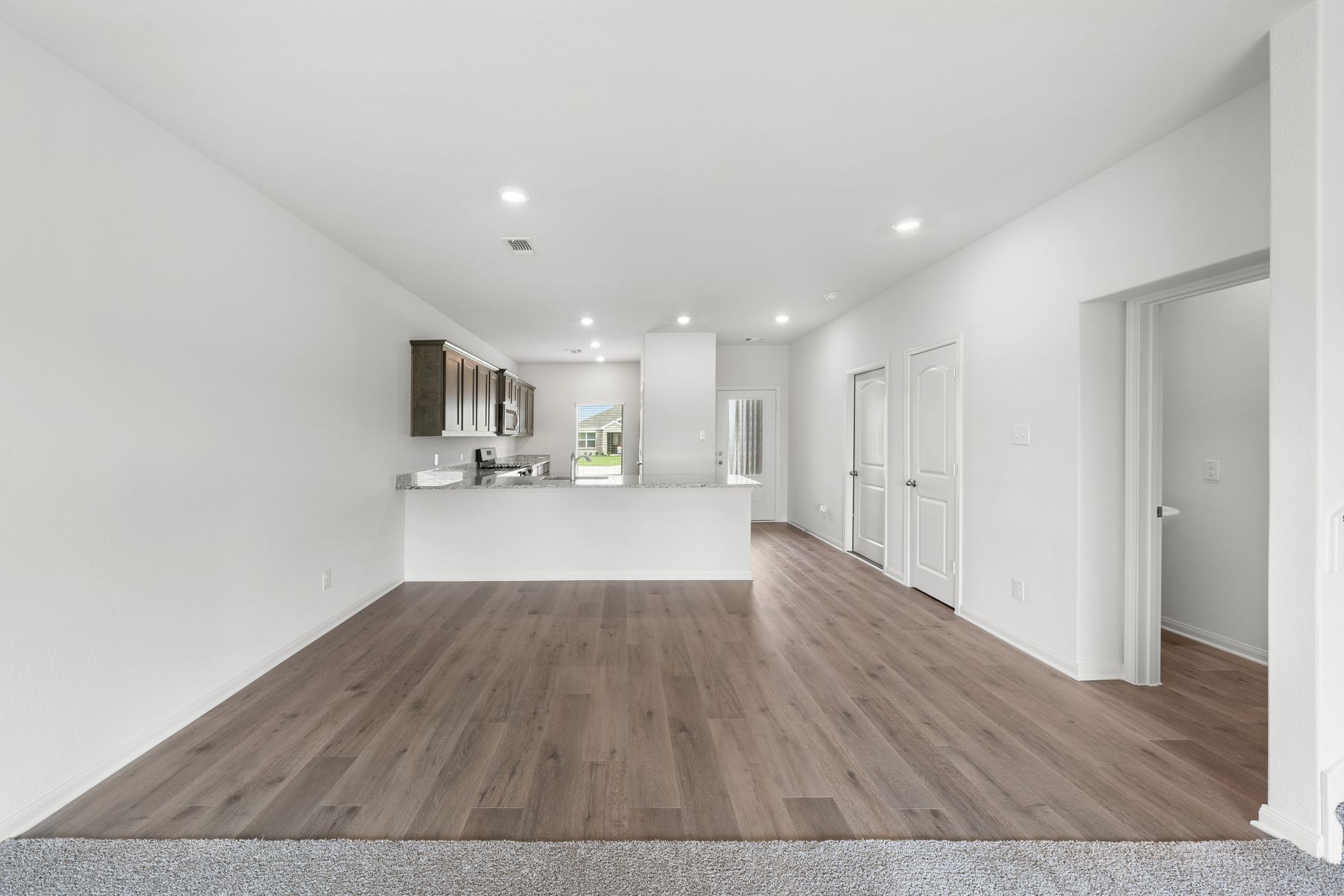The dining room sits right off of the kitchen has a large window.