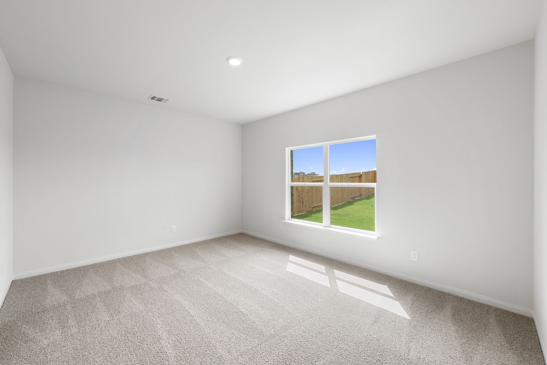 The master bedroom has a large window that lets in great, natural light.