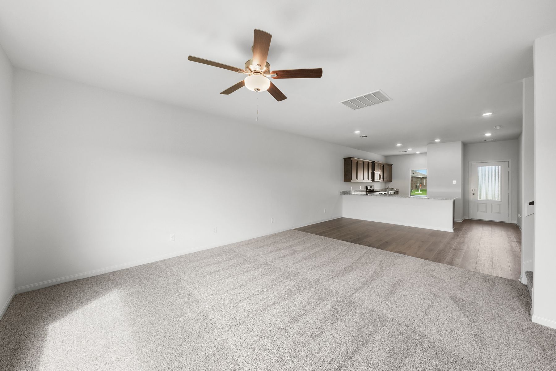 The open layout connects the kitchen with the dining room and family room.