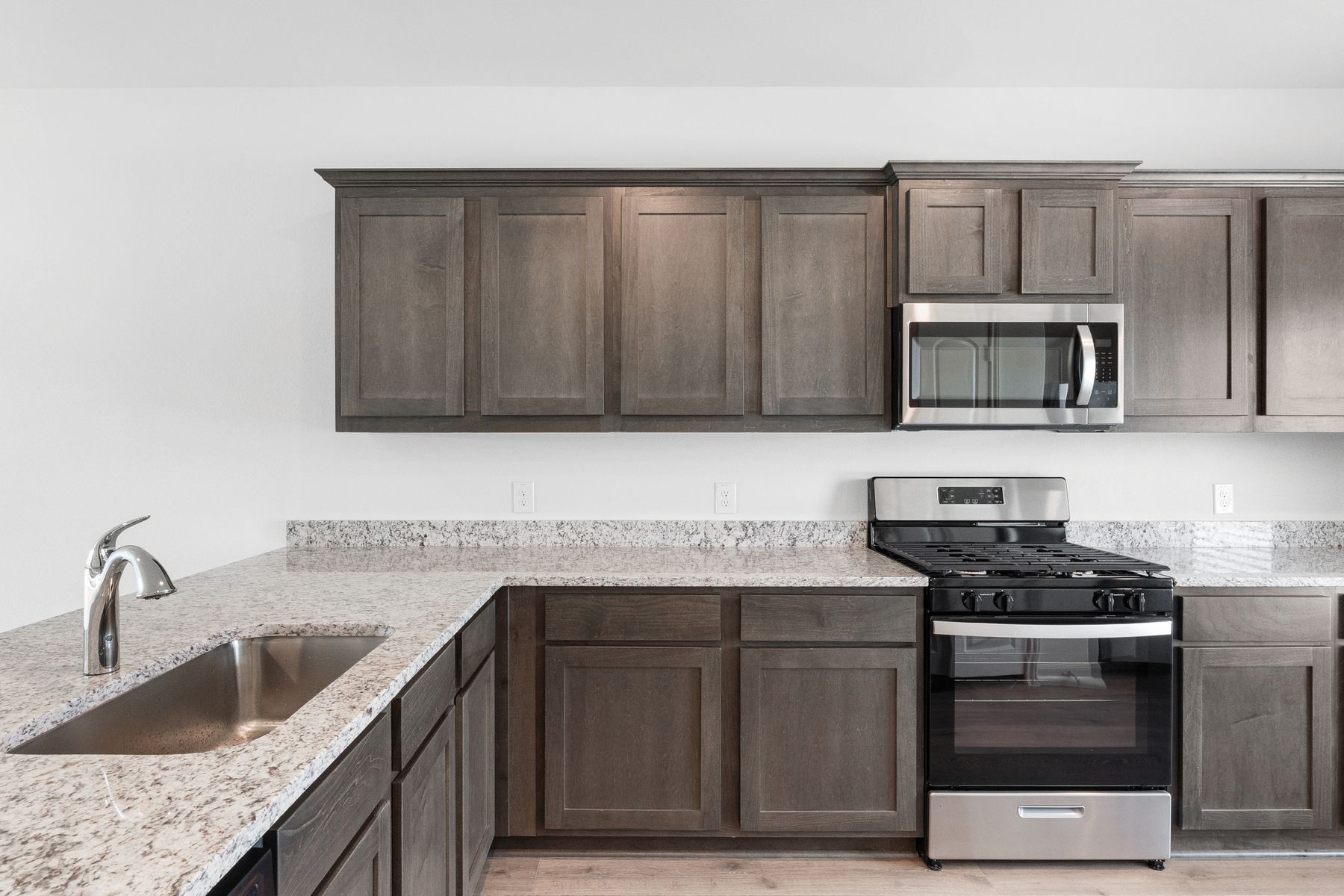The kitchen has gorgeous wood cabinetry.