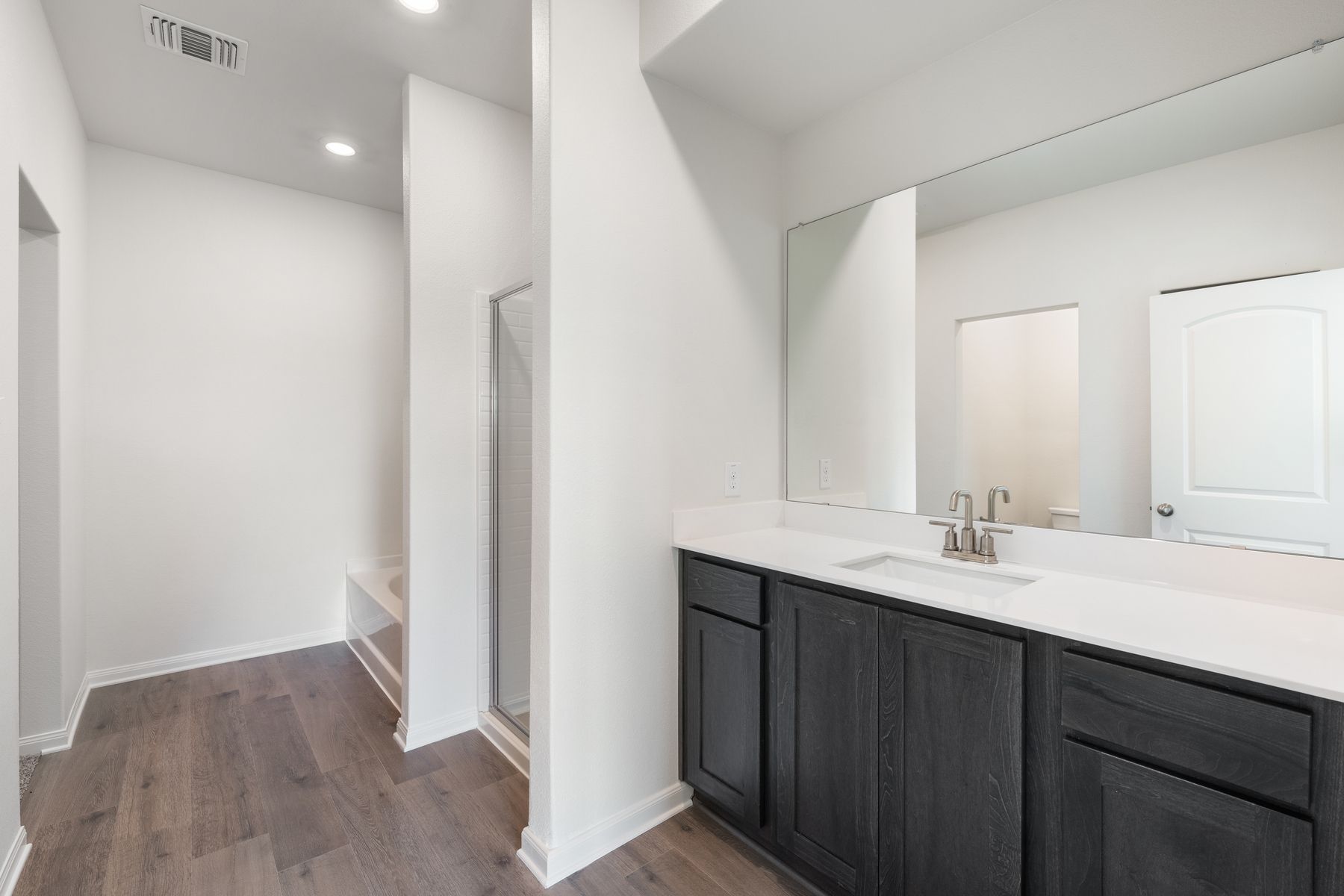 The master bathroom has a large vanity space.