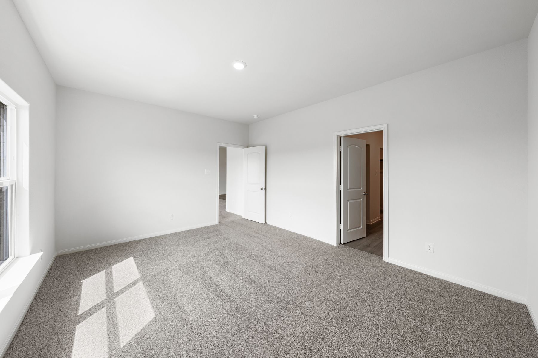 The master suite has a large bedroom, en-suite bathroom and walk-in closet.