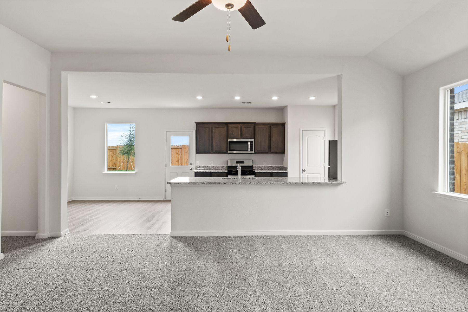 The open layout connects the family room with the kitchen and dining room.