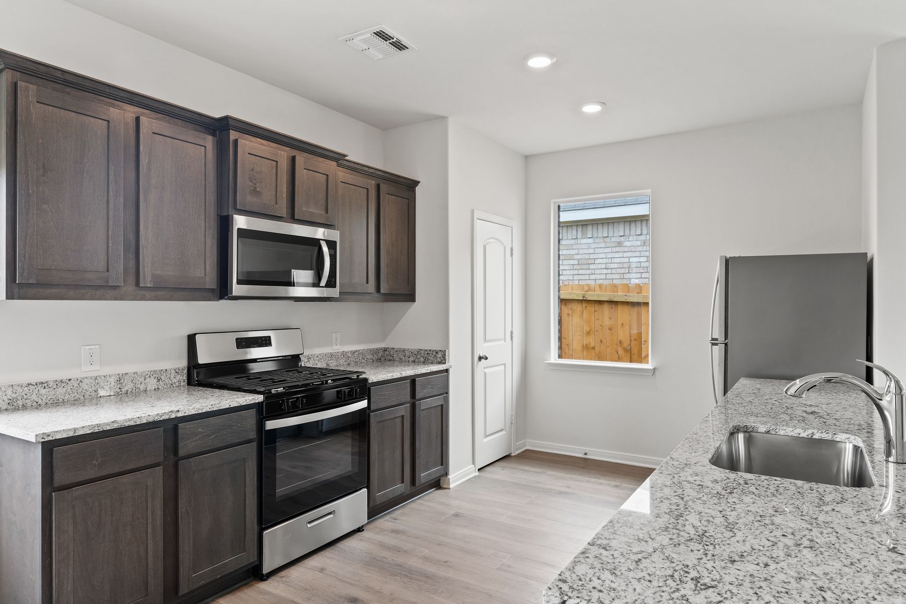 The kitchen has gorgeous wood cabinetry.