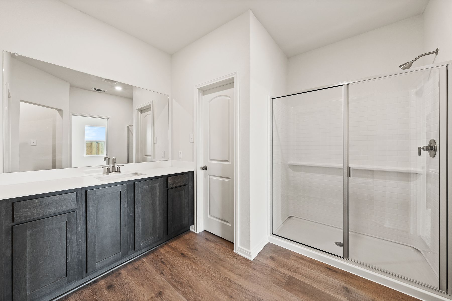 The master bathroom has a spacious vanity space.