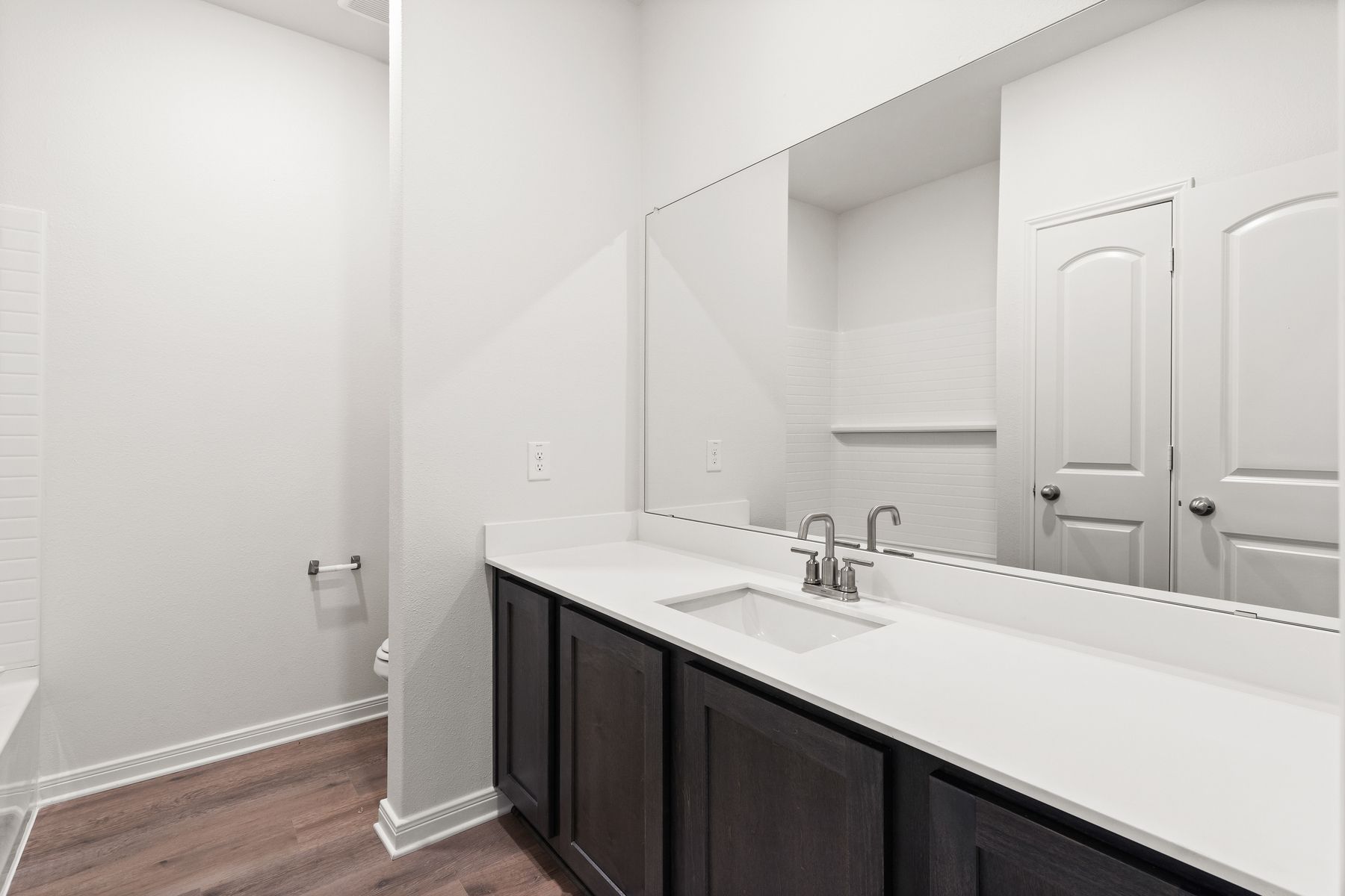 The secondary bathroom has a large vanity space.