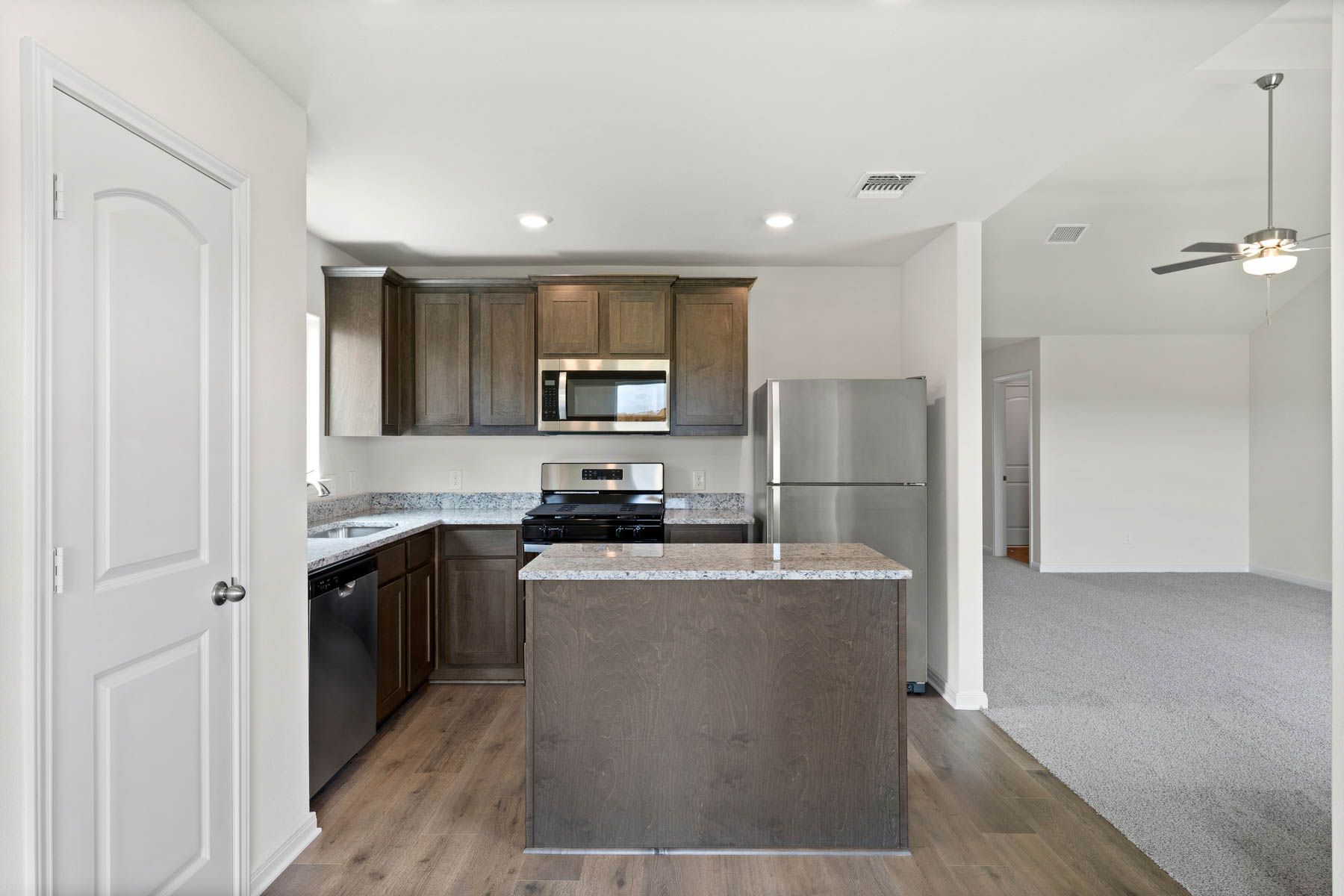 The kitchen has gorgeous wood cabinetry.