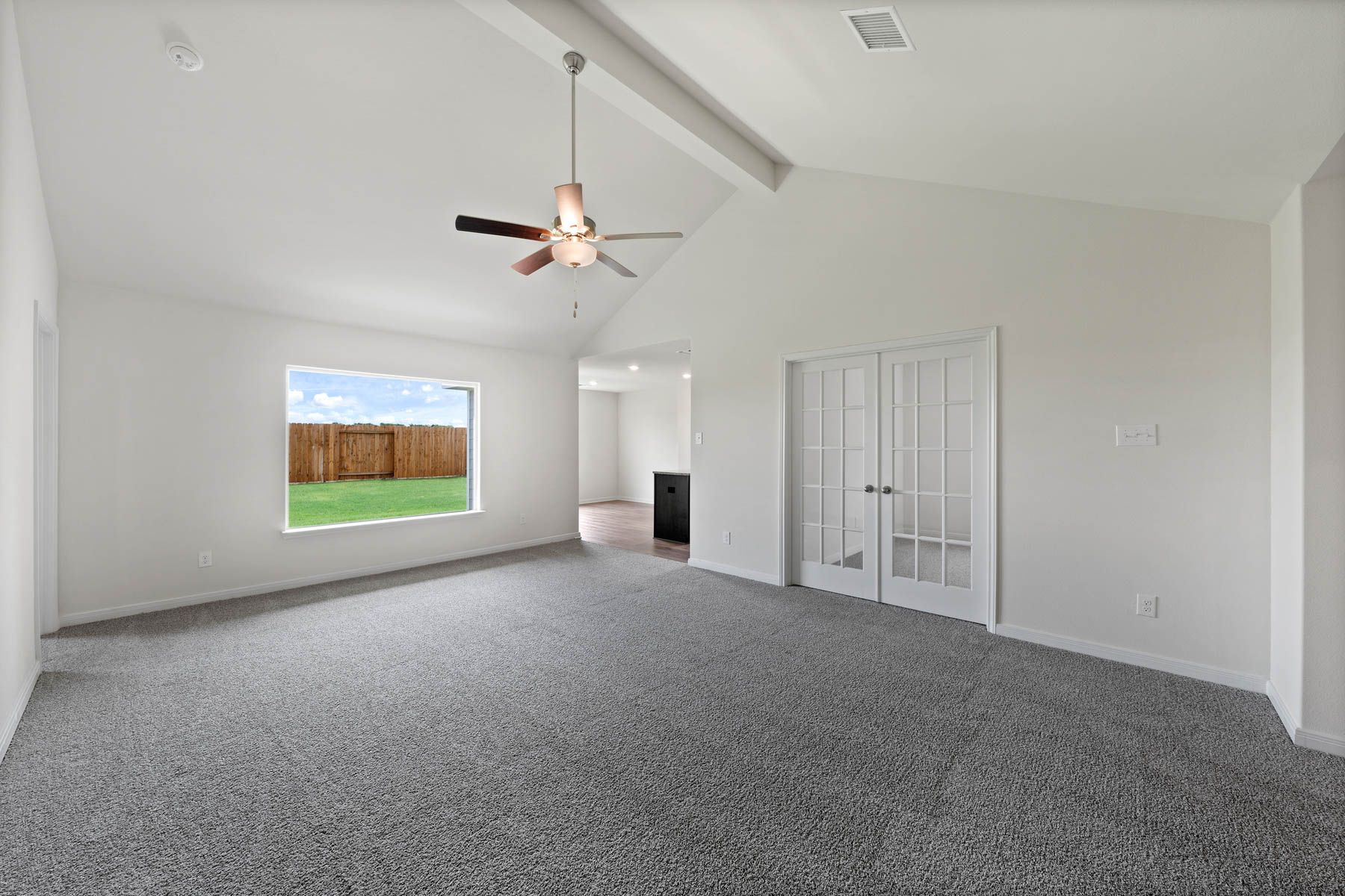 The spacious family room has a large window with great natural light and backyard views.