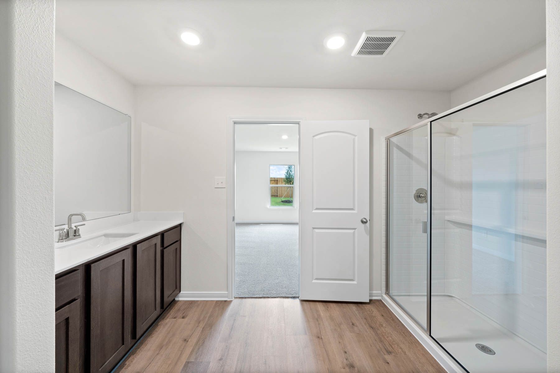 The master bathroom has a glass, walk-in shower.