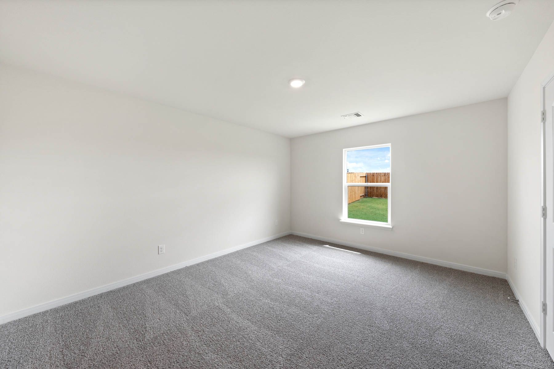 The master bedroom has a large window with great natural light and backyard views.