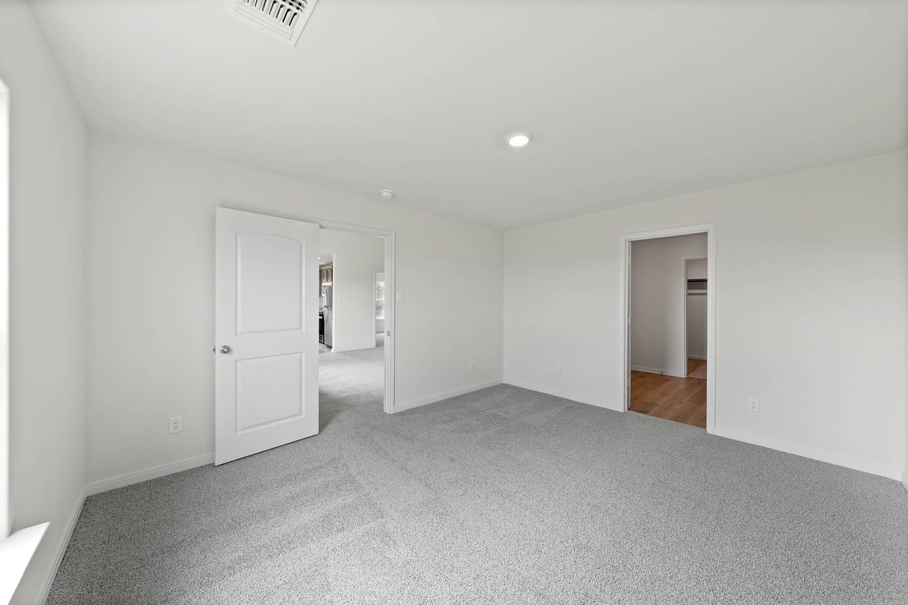 The master suite has a spacious bedroom, en-suite bathroom and walk-in closet.