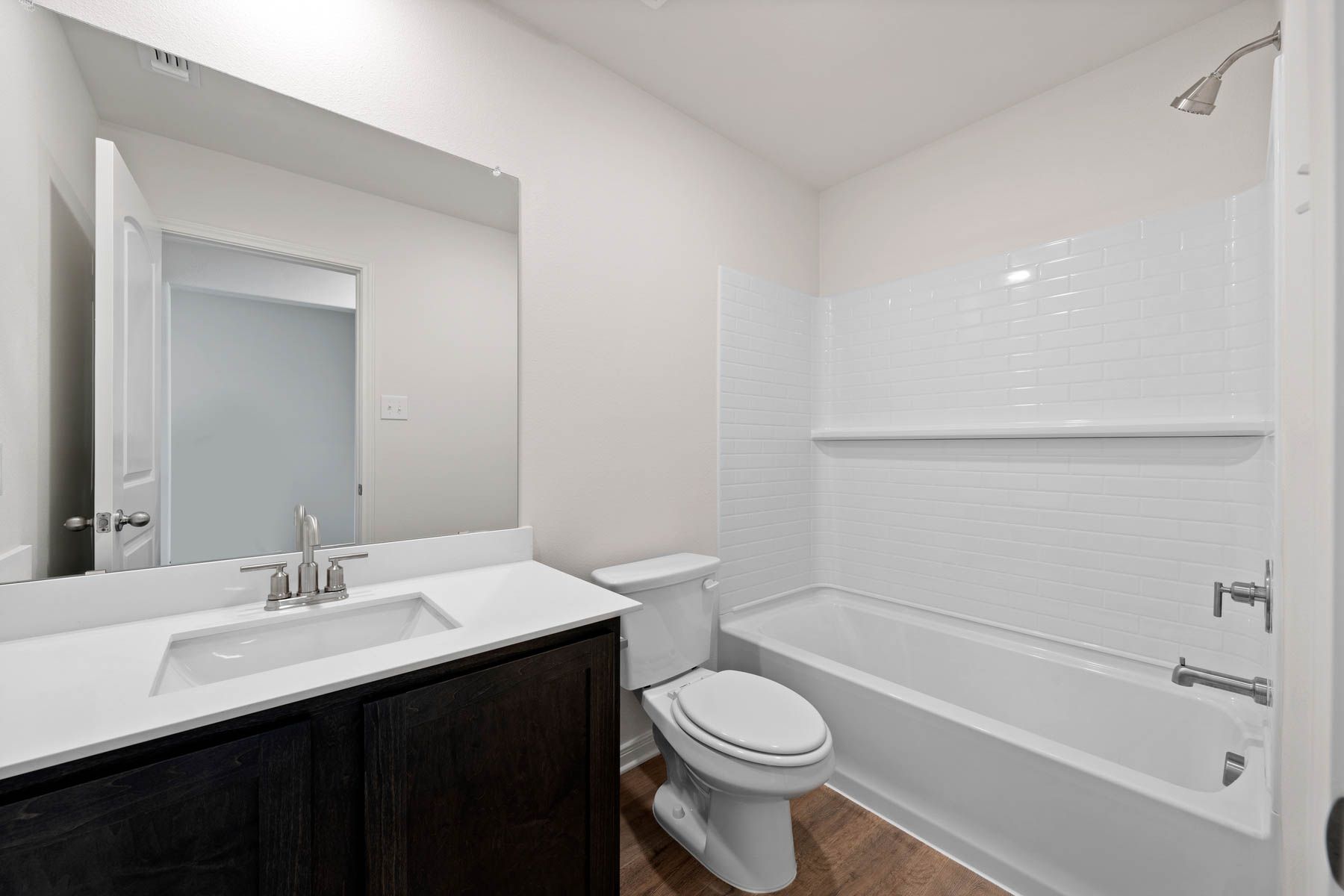 The secondary bathroom has a large vanity space.