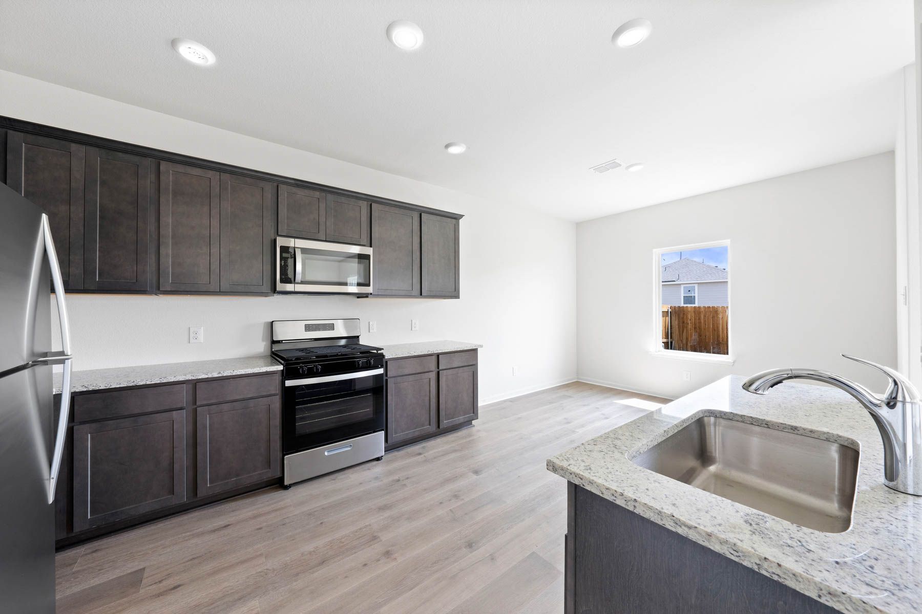 The kitchen has gorgeous wood cabinetry.