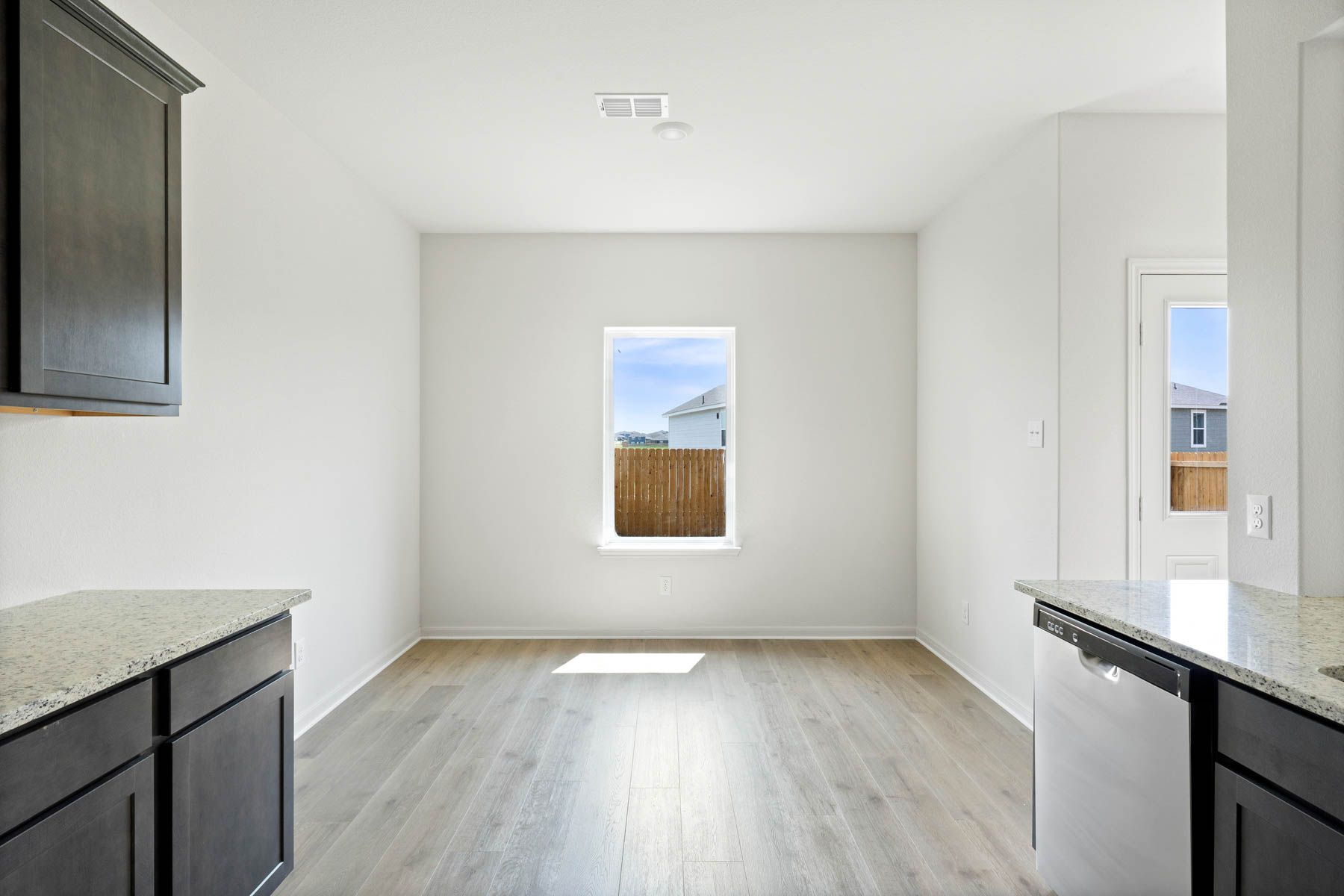 The dining room sits right off of the kitchen and has a large window.