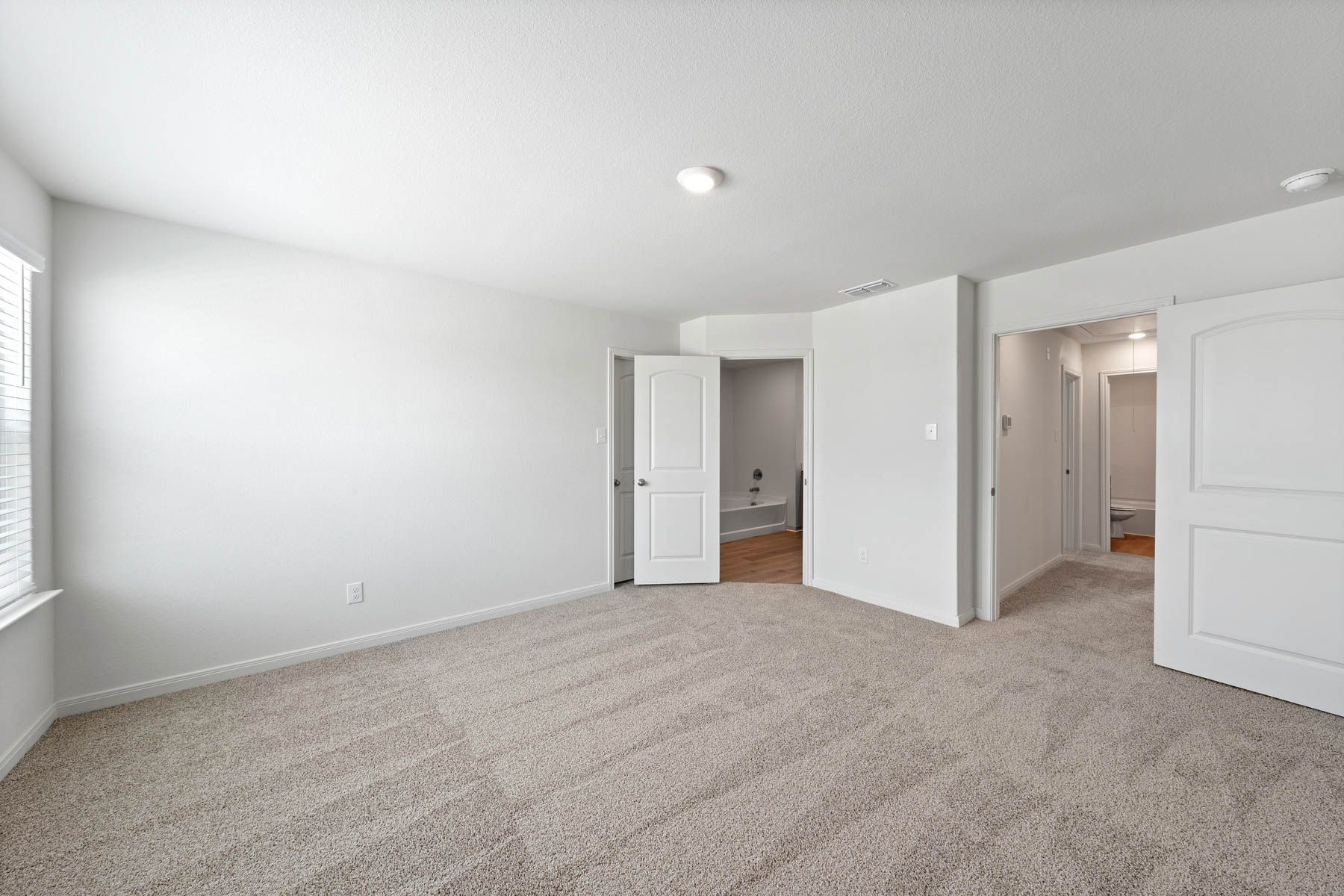 The master suite has a spacious bedroom, en-suite bathroom and walk-in closet.