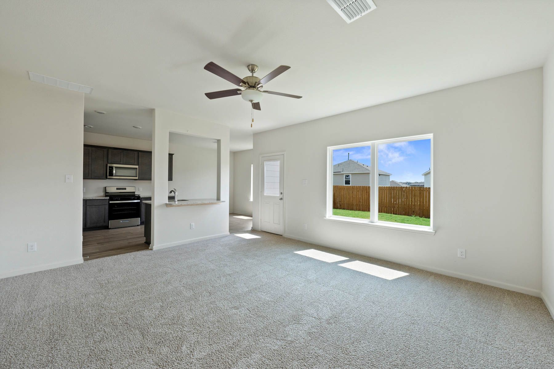 The open-concept layout of this floor plan has the kitchen, family room and dining room sitting next to one another.