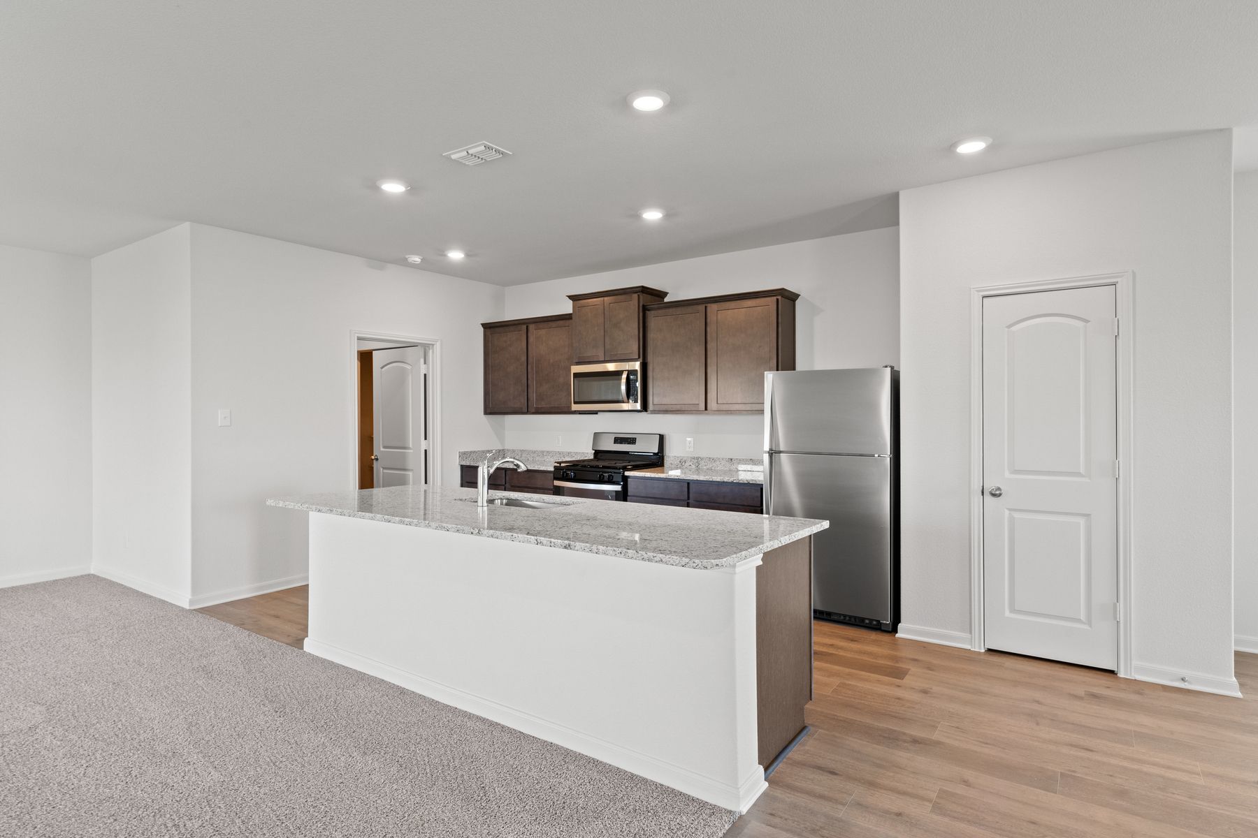 The kitchen has sprawling granite countertops.