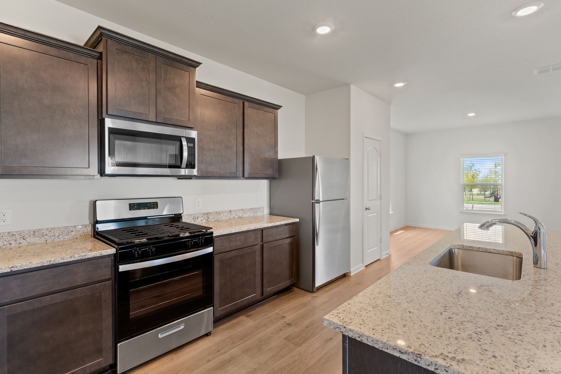 The kitchen has gorgeous wood cabinetry.