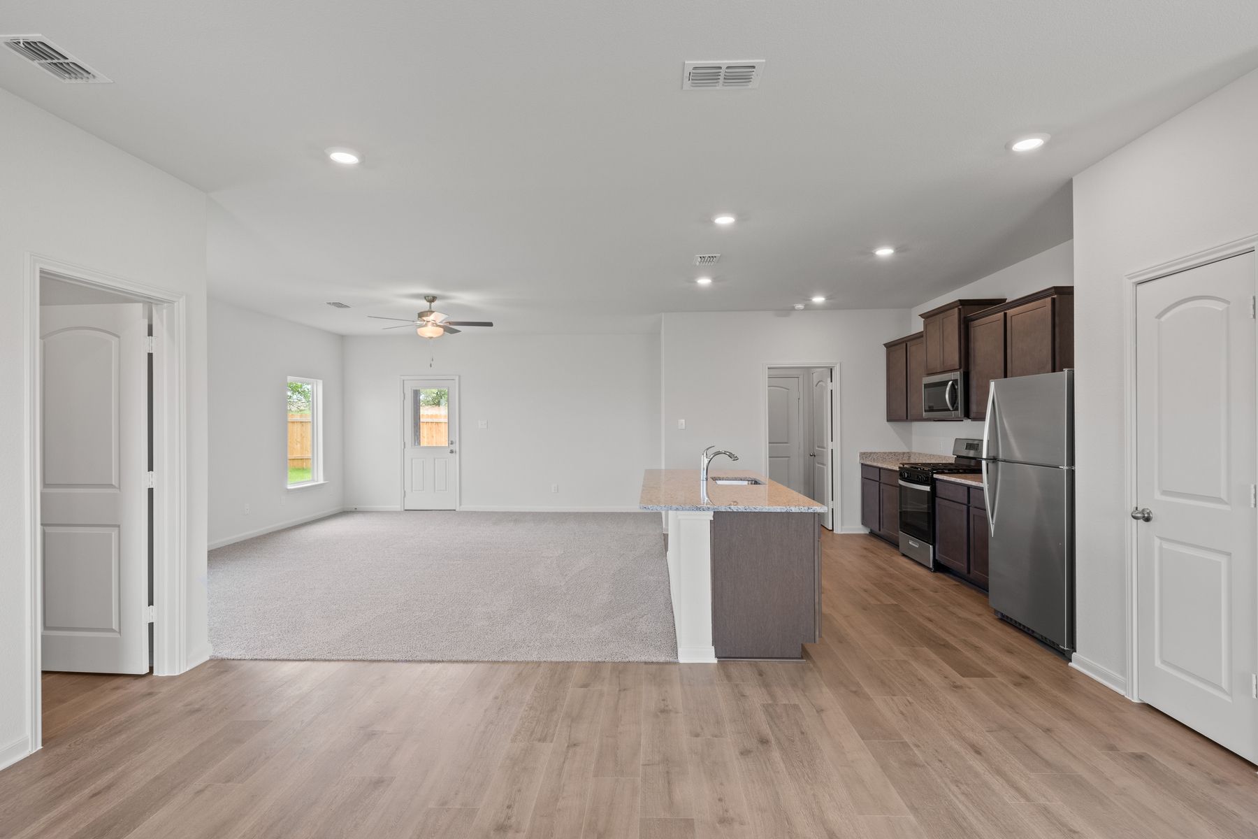 The open-concept layout of this floor plan has the kitchen, family room and dining room sitting next to one another.