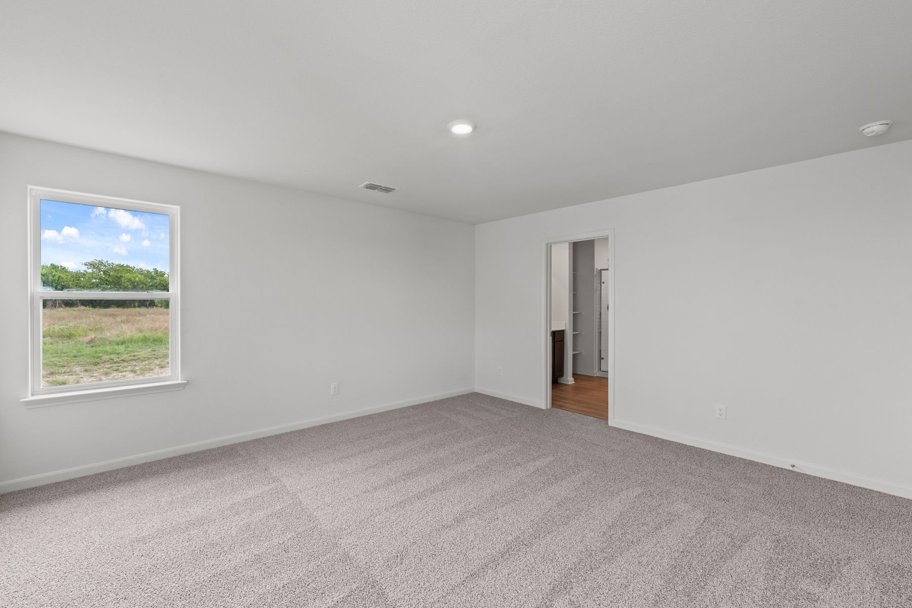 The master suite has a spacious bedroom, en-suite bathroom and walk-in closet.